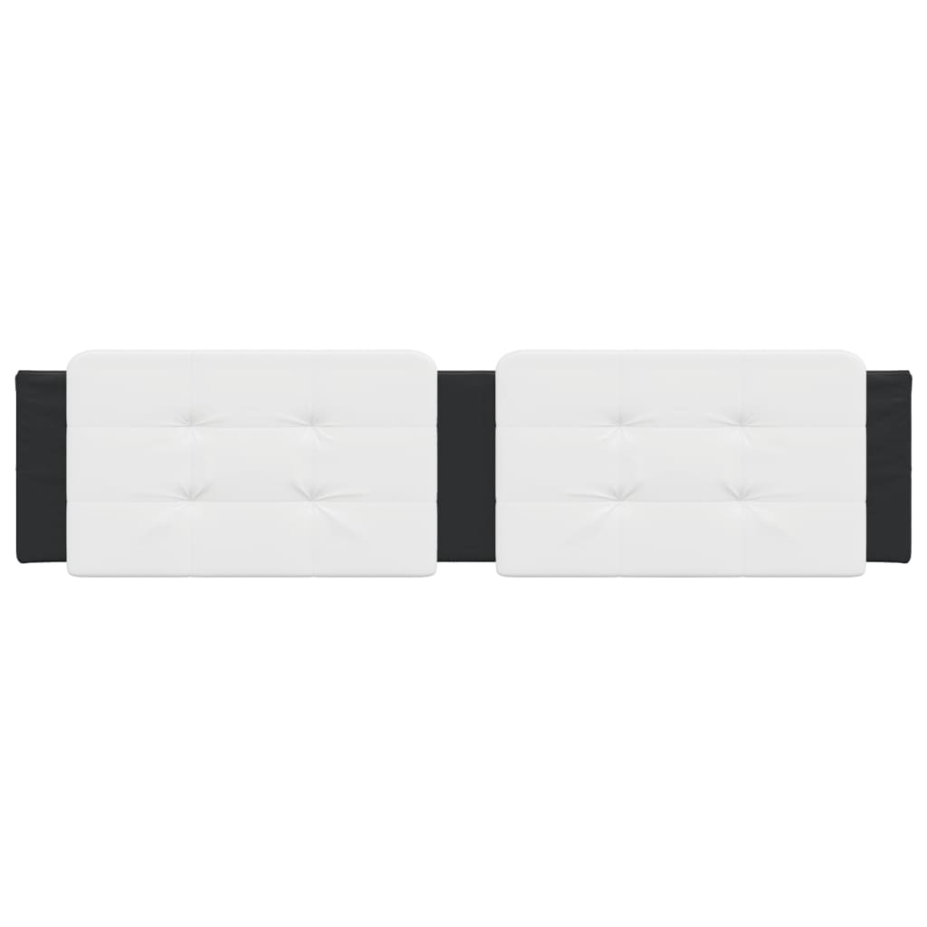Two tufted white upholstered headboard panels mounted on a black base above a bed