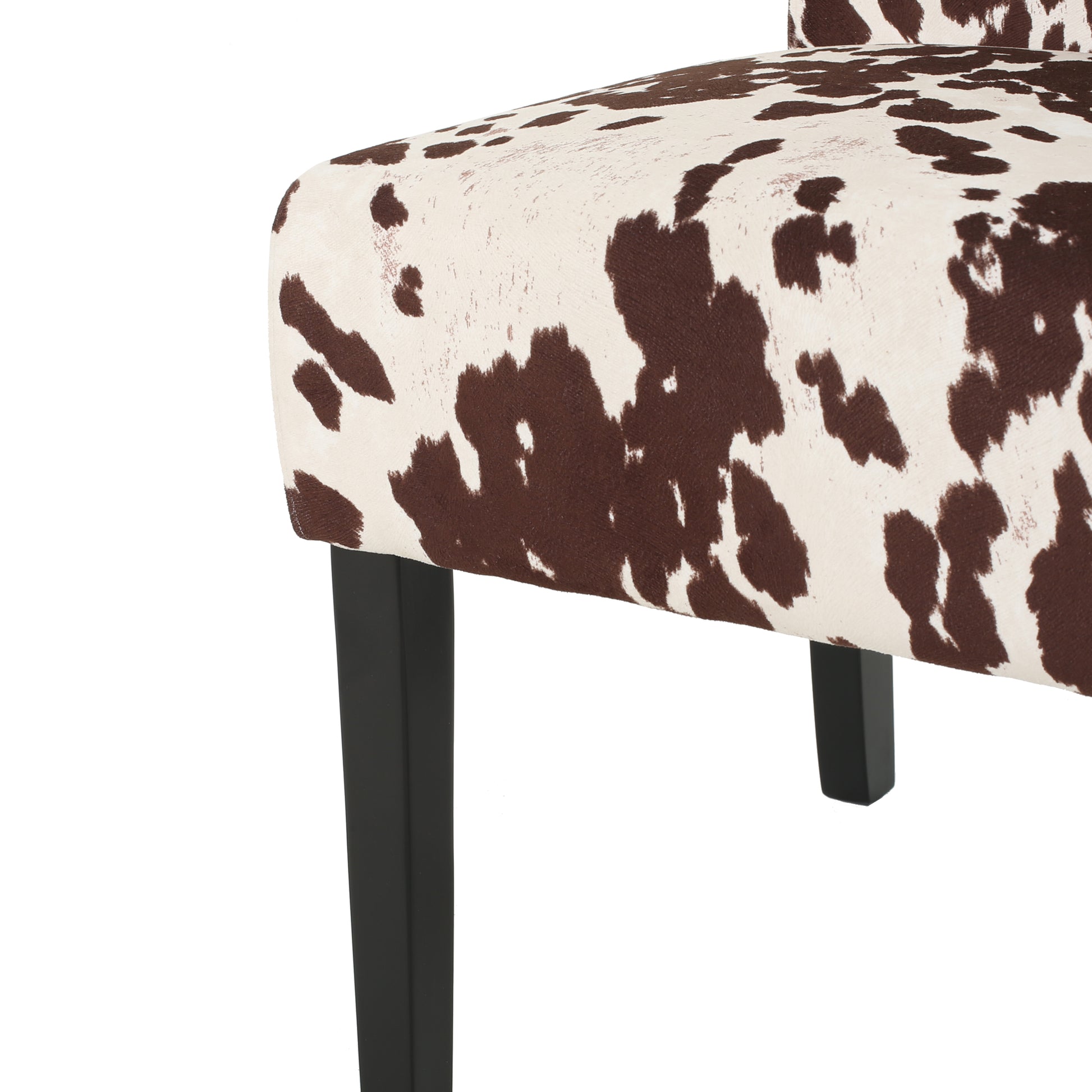 Brown and white cow print accent chair fabric detail