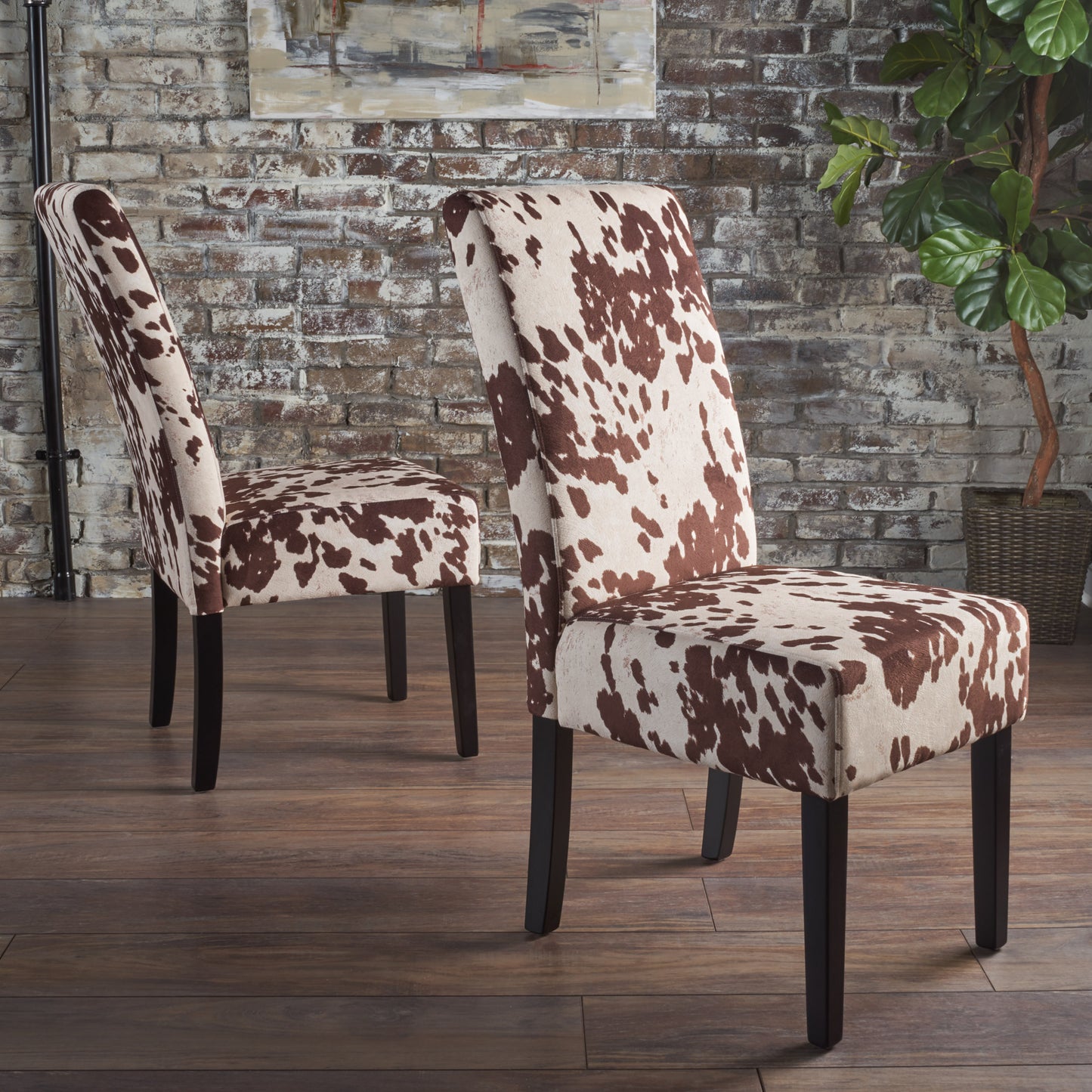 Brown and white cow print dining chair with dark wood legs