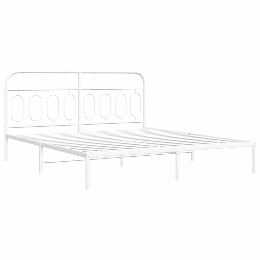 White metal bed frame with a minimalist arched headboard styled with grey bedding