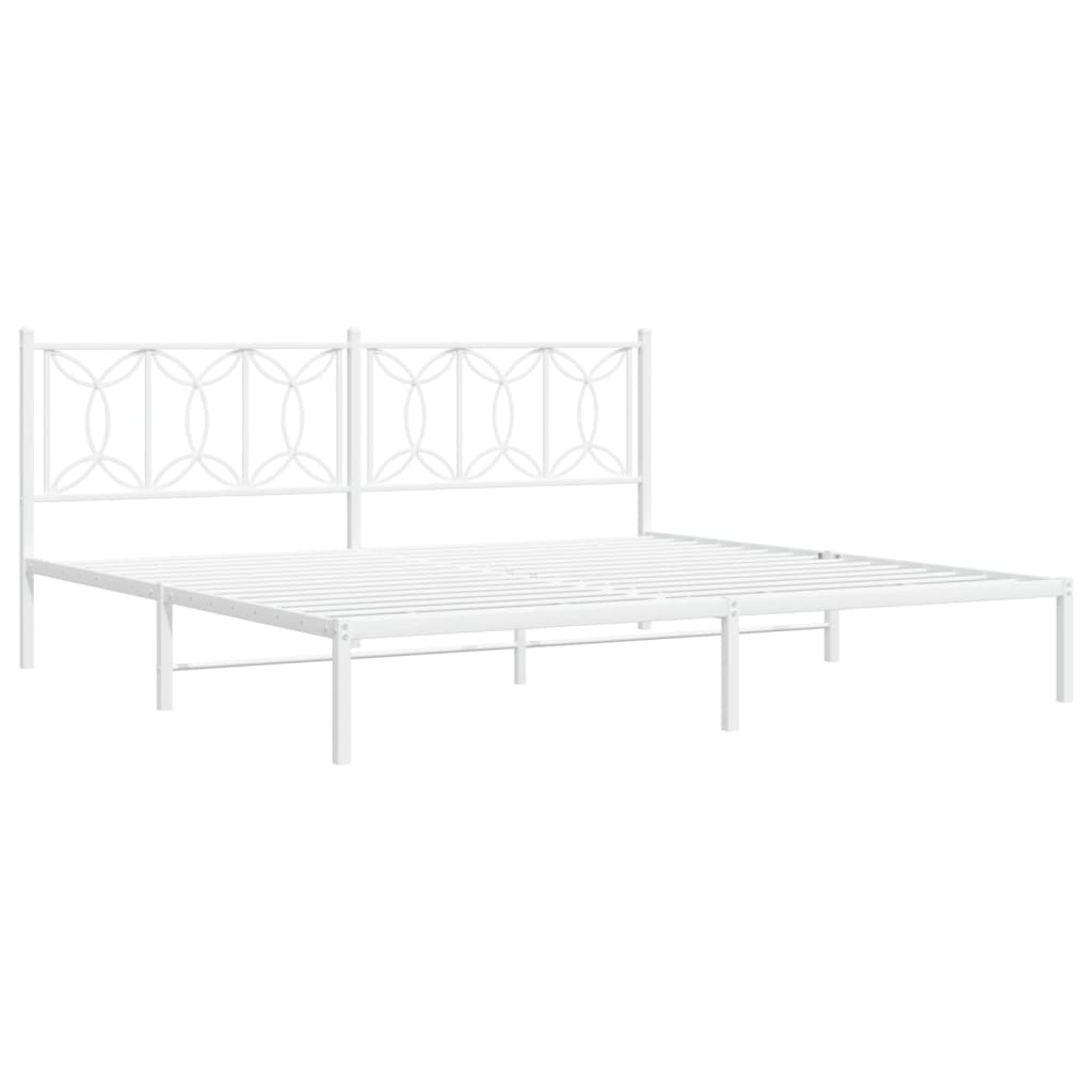 White metal bed frame with decorative headboard and upholstered mattress