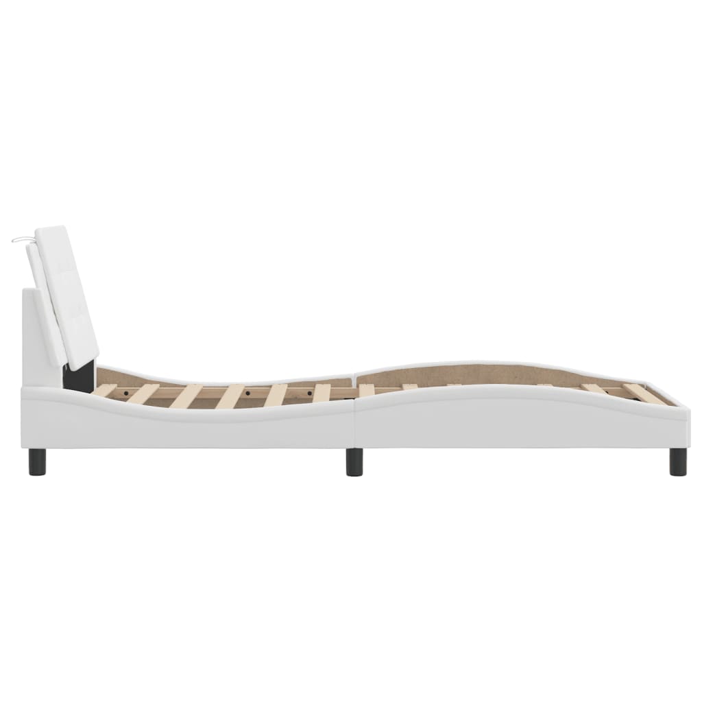 White upholstered platform bed with tufted headboard and wooden slats