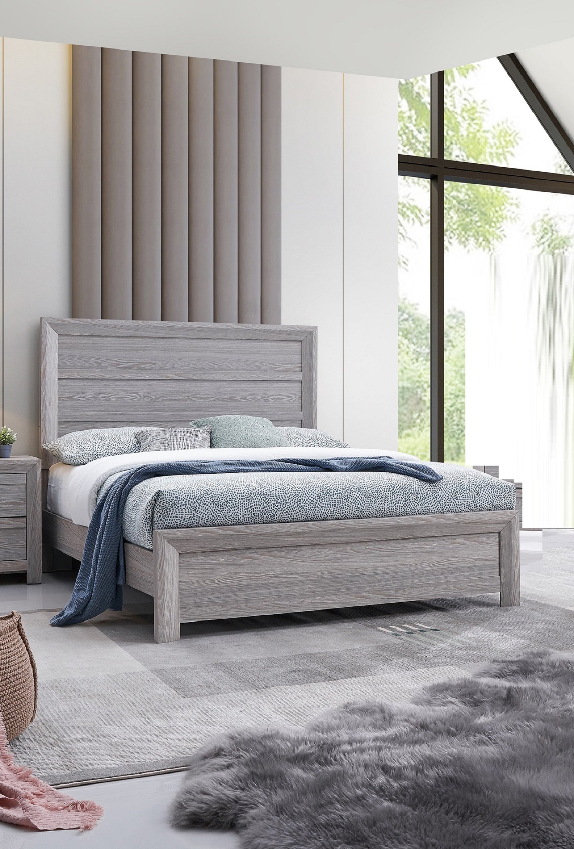 Grey wooden platform bed with blue and white patterned bedding