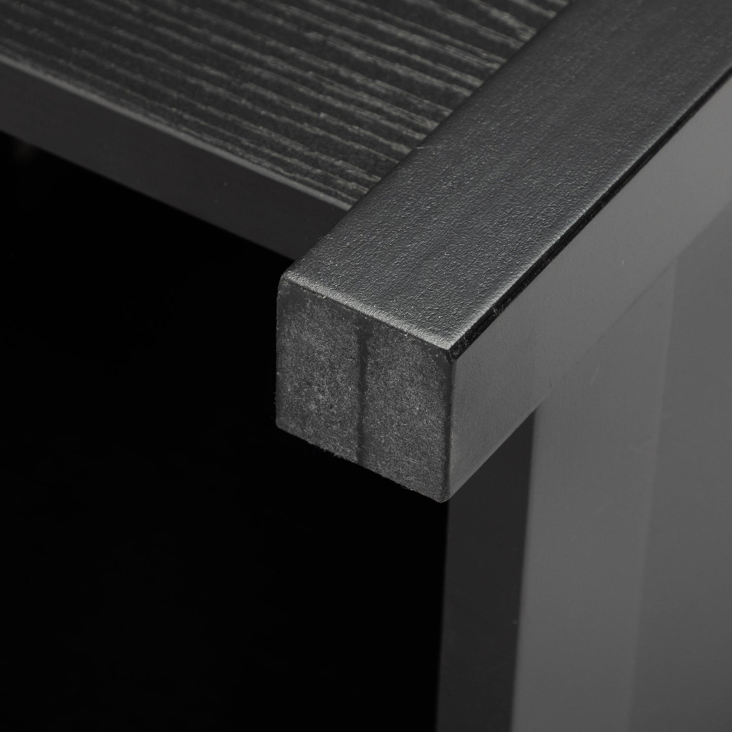 Black textured metal frame on dark wood grain shelf