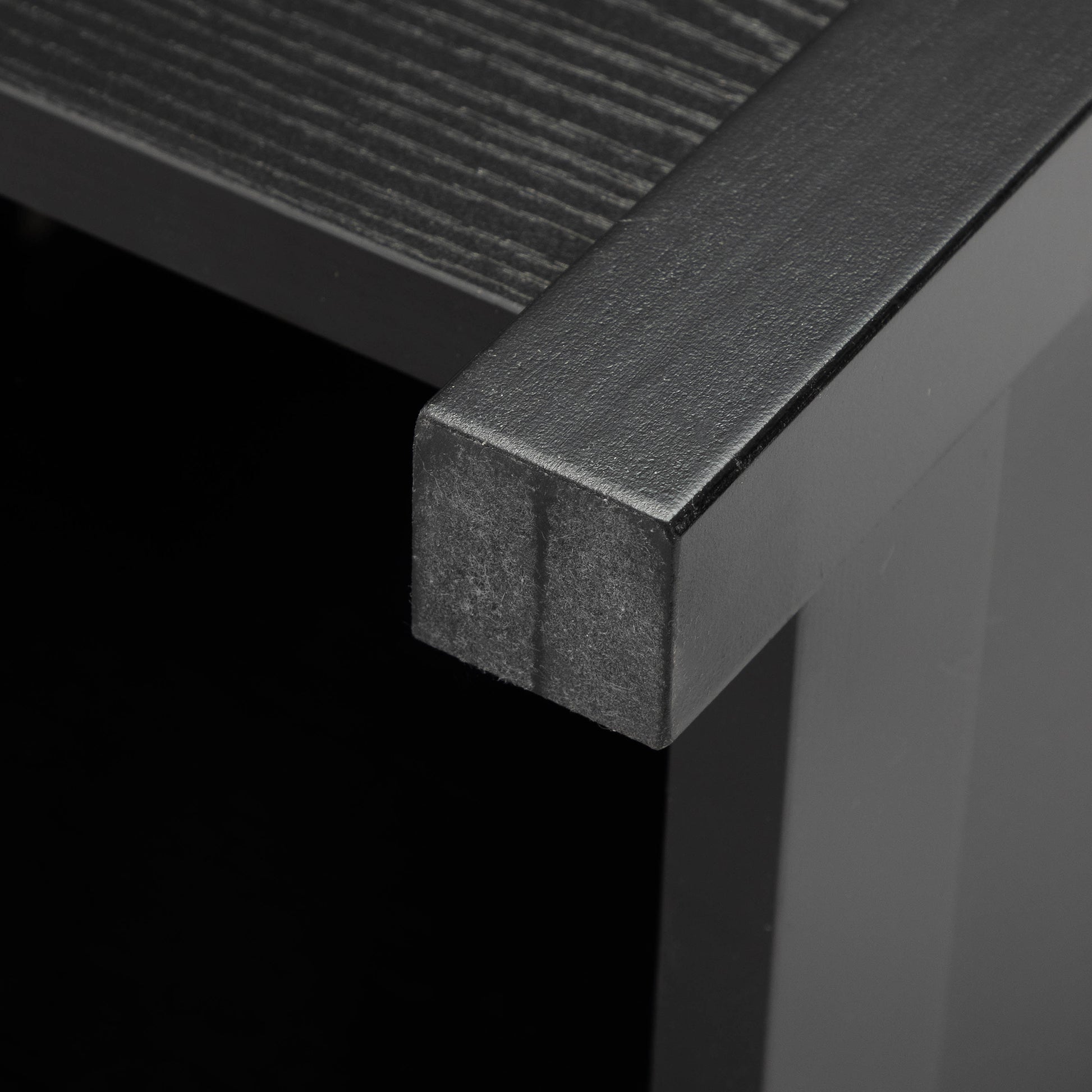 Black textured metal frame on dark wood grain shelf
