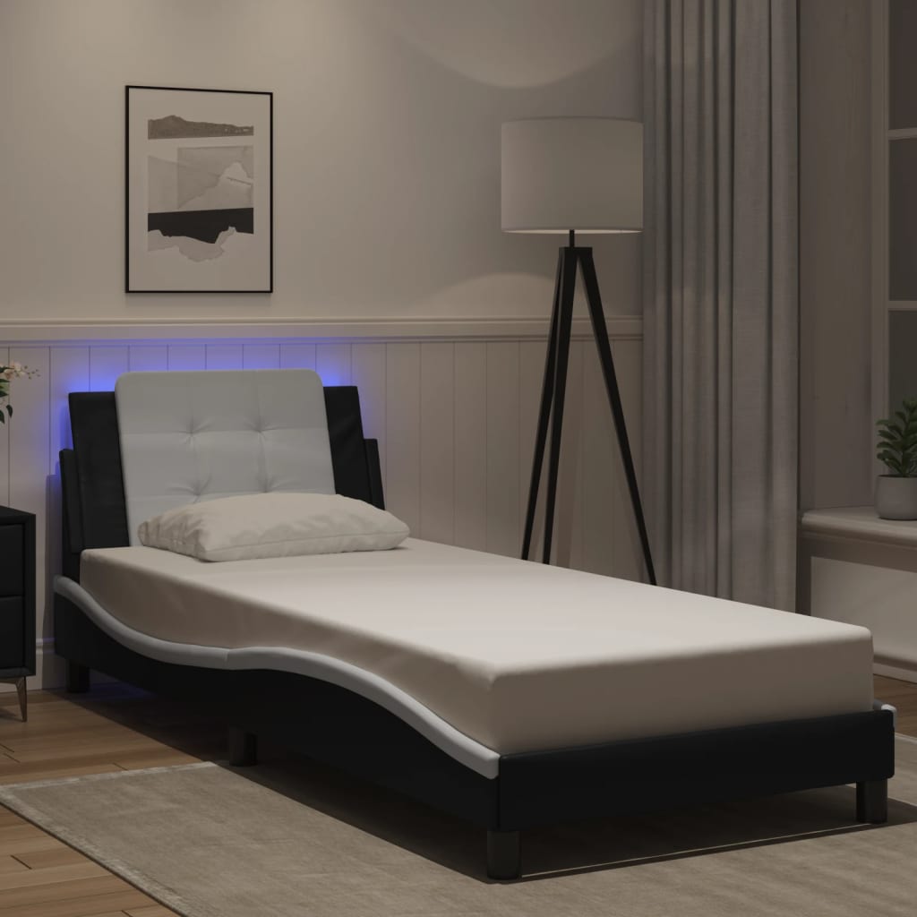 Modern black faux leather chaise lounge with white tufted headboard and builtin LED lights