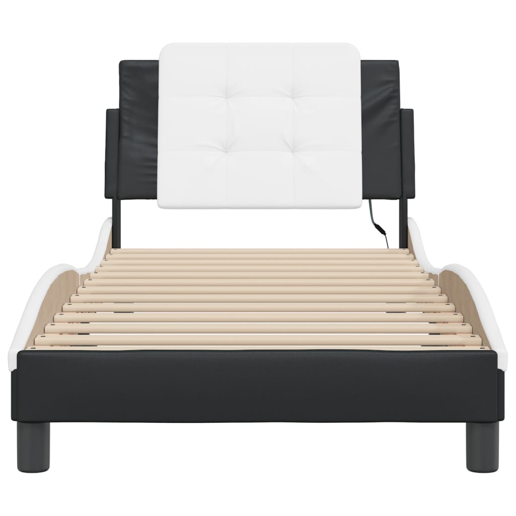 Modern black and white upholstered chaise lounge with button tufted headrest