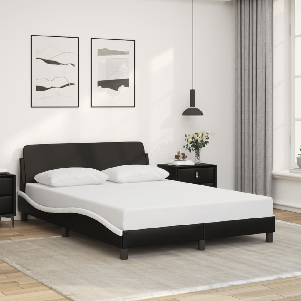 Modern black faux leather bed frame with white curved accents and two pillows