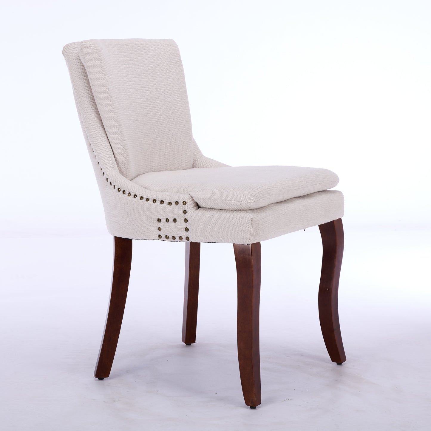 Cream upholstered dining chair with nailhead trim and dark wood legs