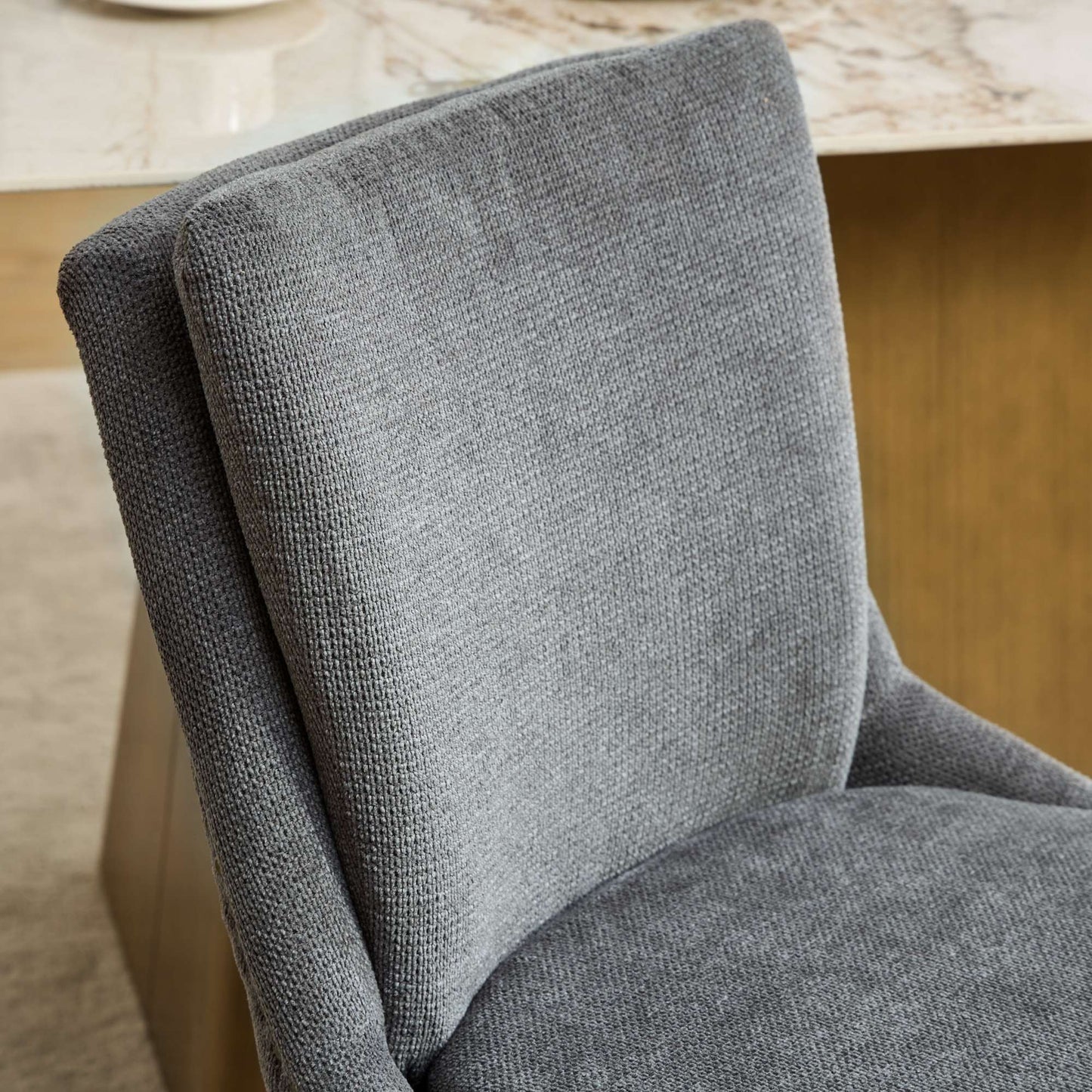 Close up of textured grey fabric on a modern accent chair