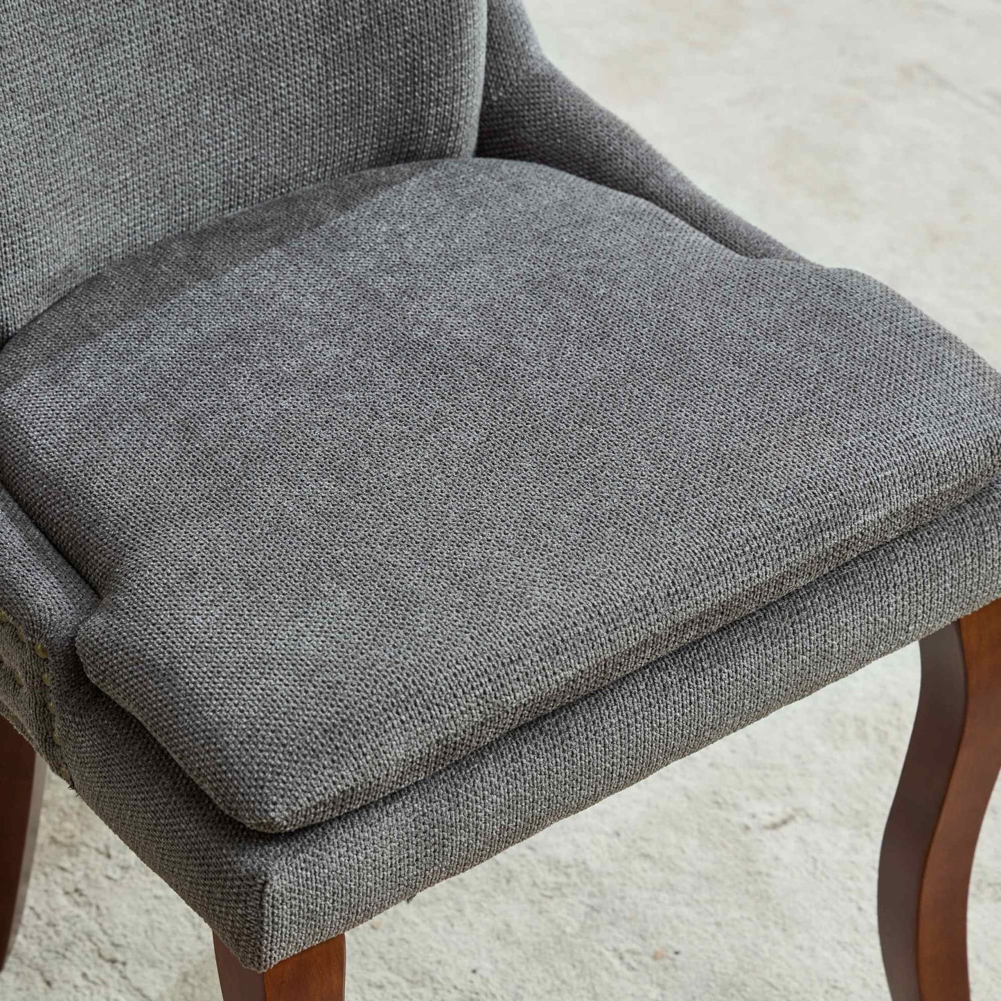 Grey fabric accent chair seat with comfortable cushioning