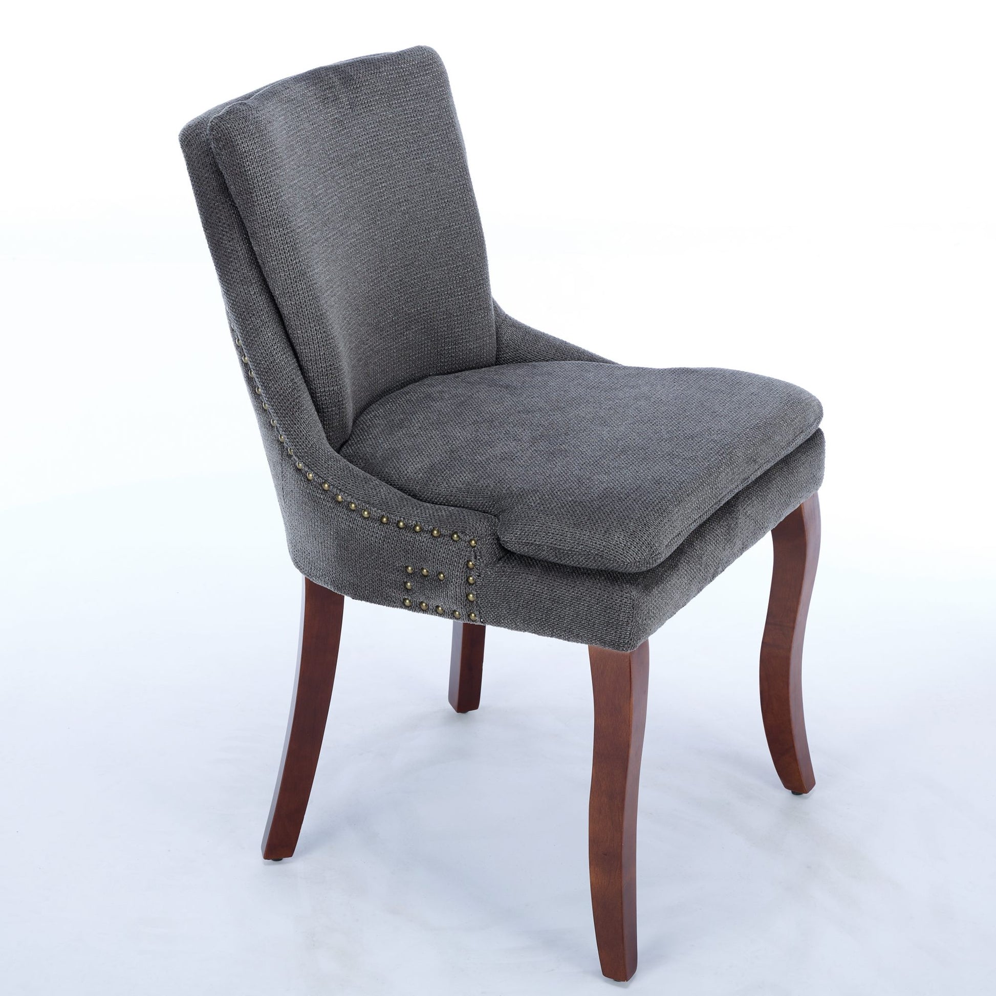 Gray upholstered accent chair with gold nailhead trim and dark wood legs