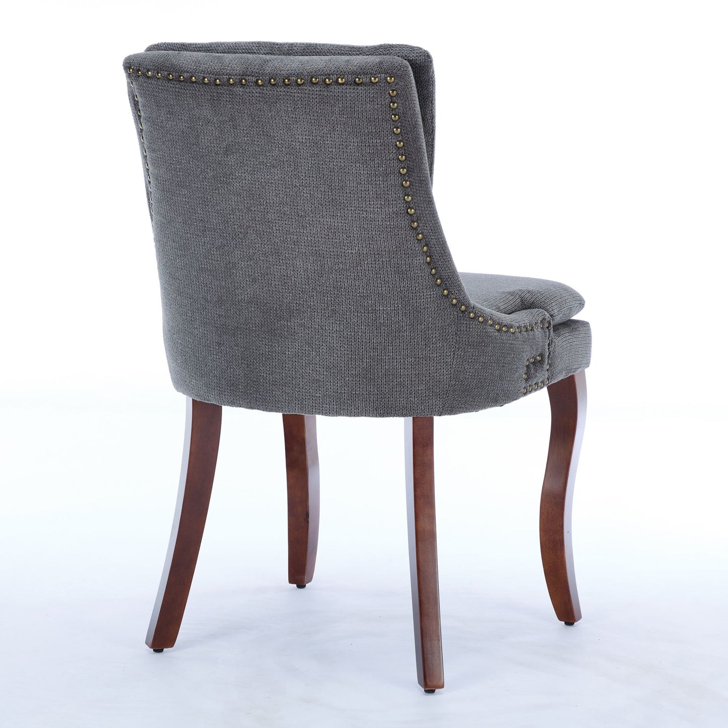 Gray upholstered dining chair with nailhead trim and dark wood legs