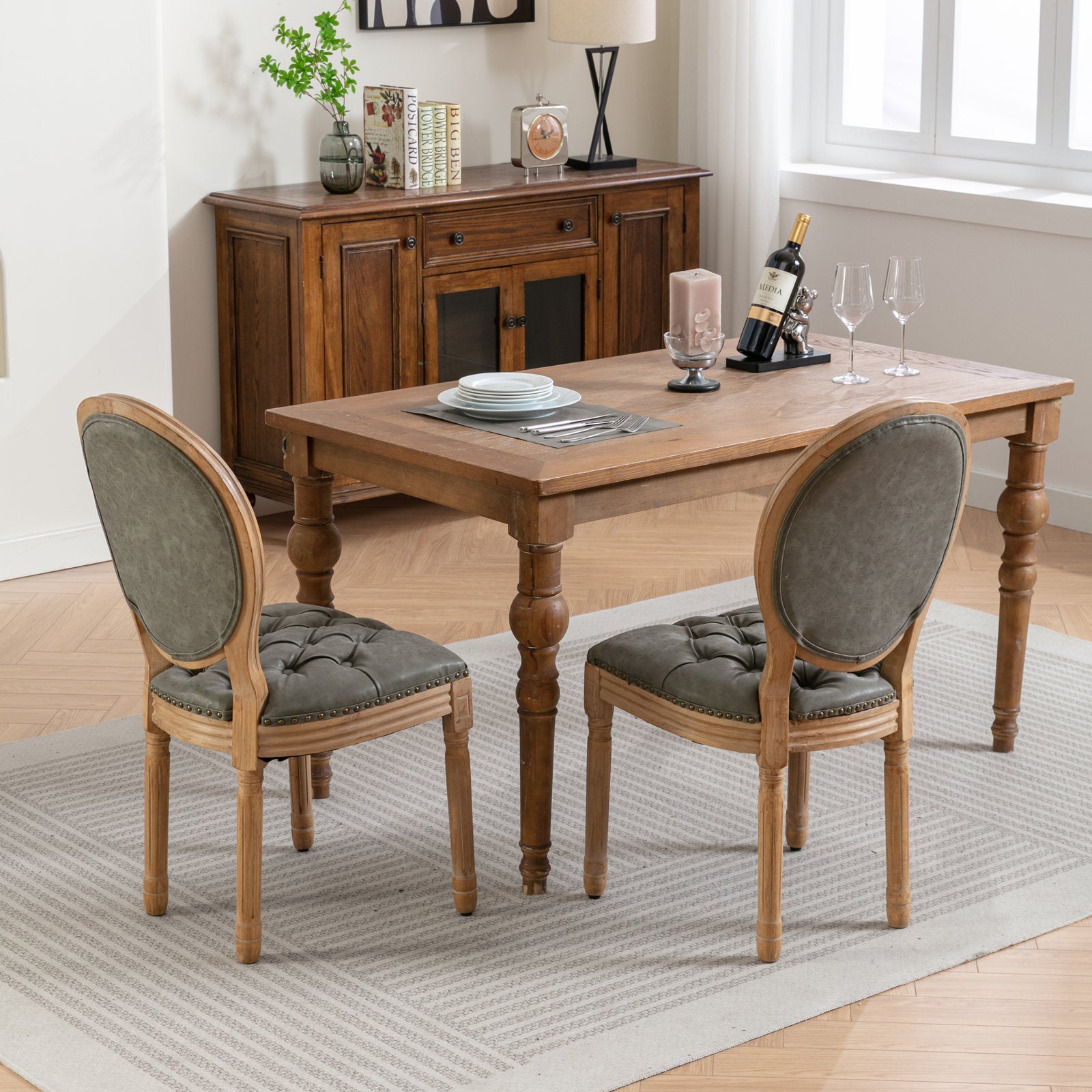 Tufted grey upholstered dining chairs with distressed wooden frames arranged around a wooden dining table