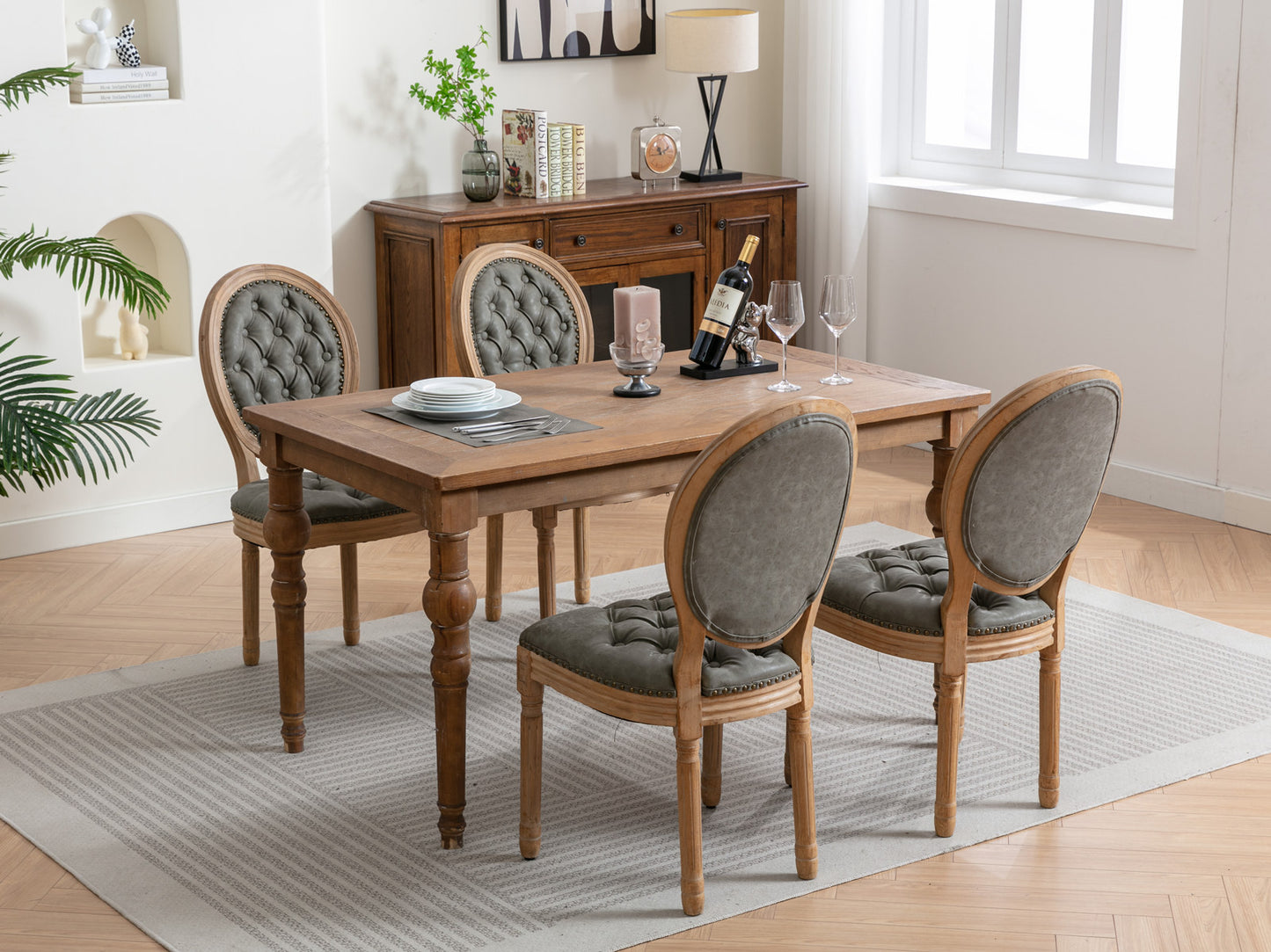 Wooden dining table with four upholstered gray chairs