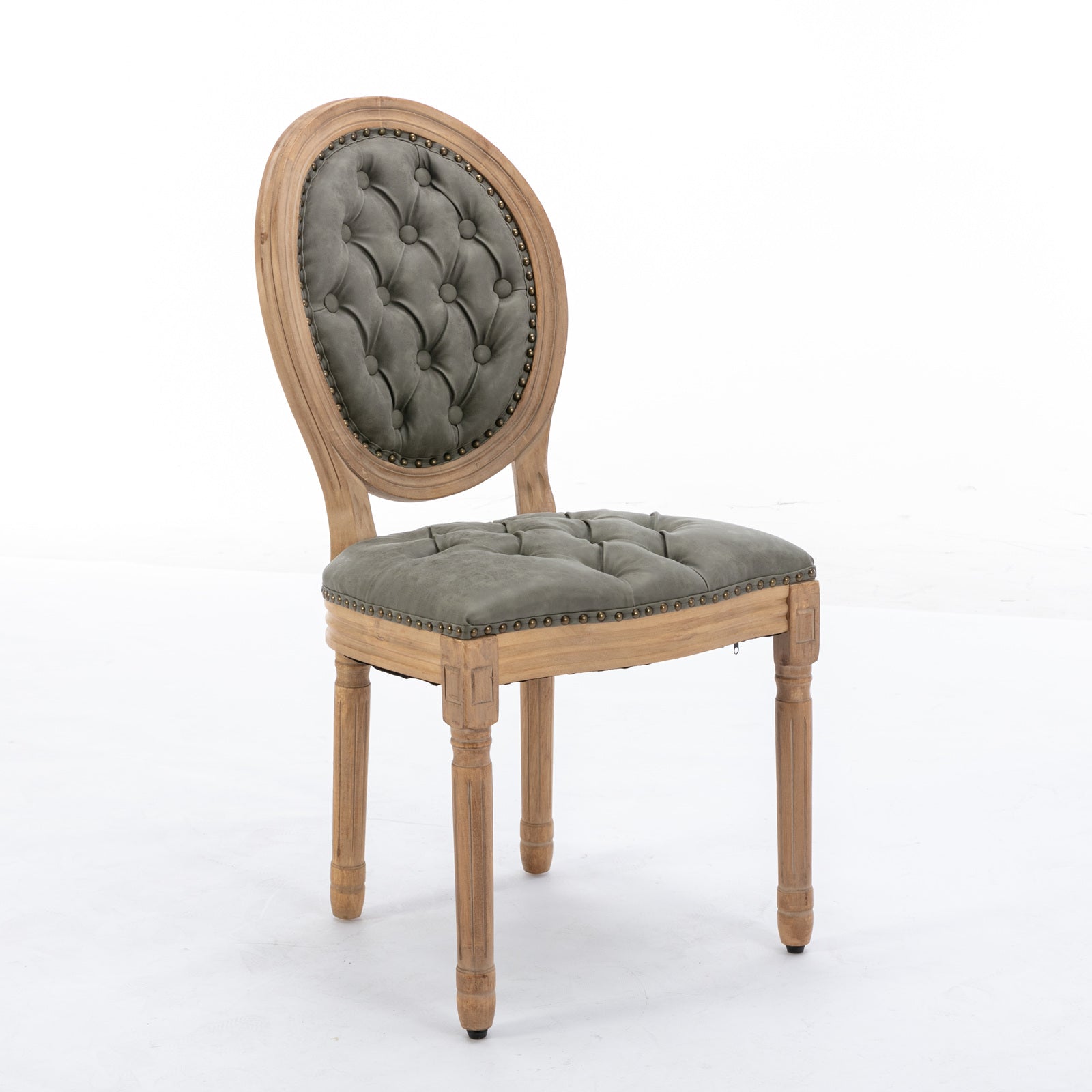 Tufted grey velvet accent chair with carved wooden frame and brass nailhead trim