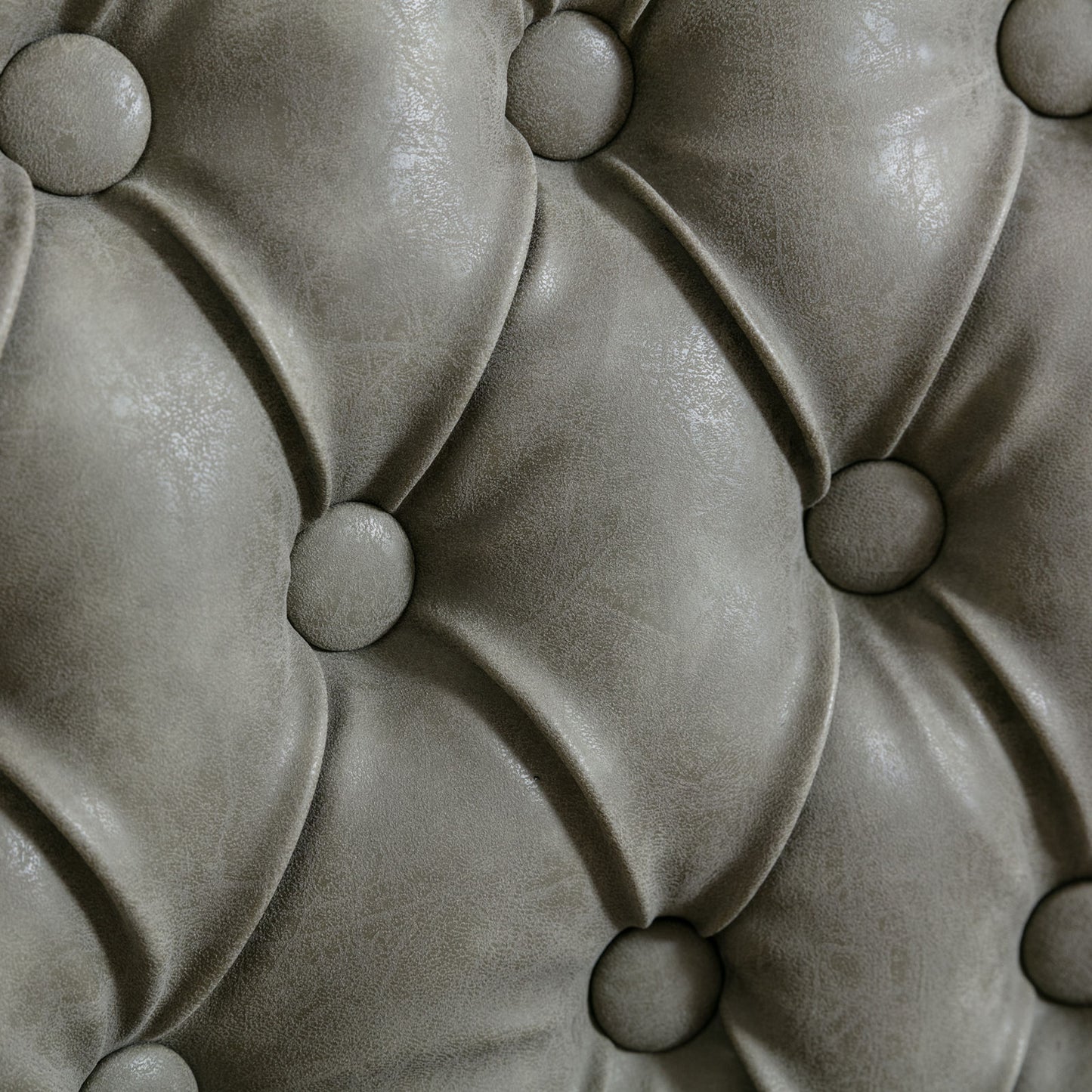 Closeup of grey faux leather tufted upholstery fabric