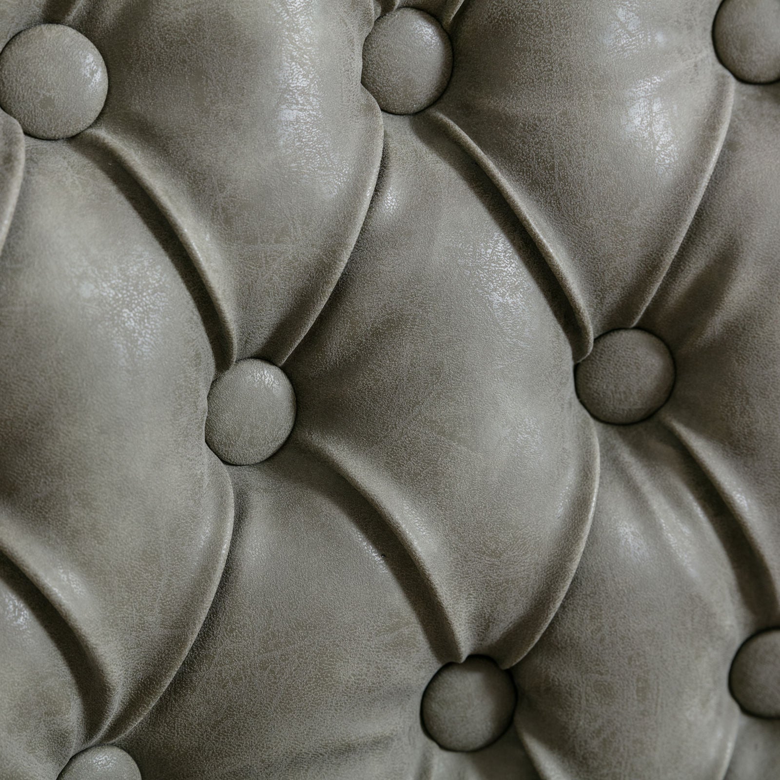 Closeup of grey faux leather tufted upholstery fabric
