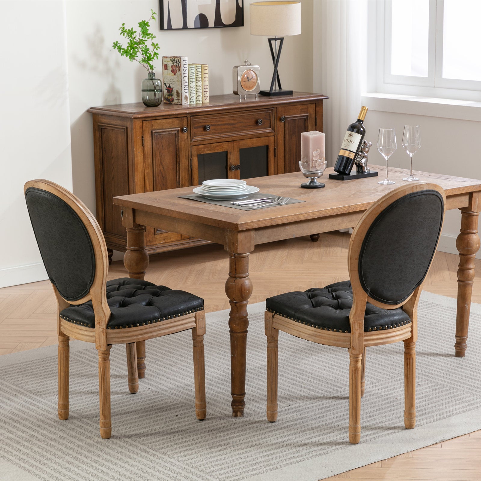 Elegant tufted armchair with black faux leather upholstery and distressed wood frame