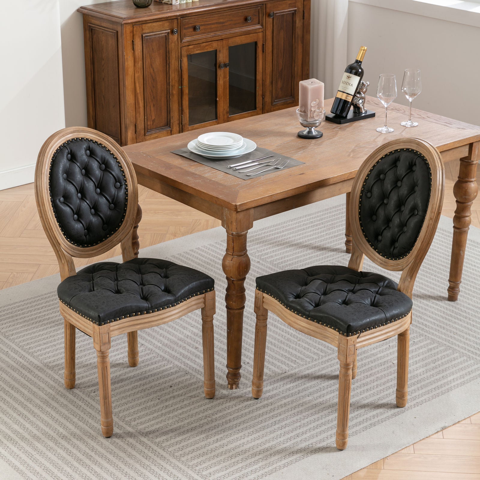 Black upholstered dining chair with tufted details and nailhead trim