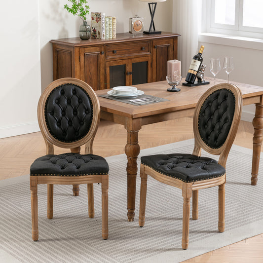 Tufted black leather dining chair with distressed wood frame and nailhead trim