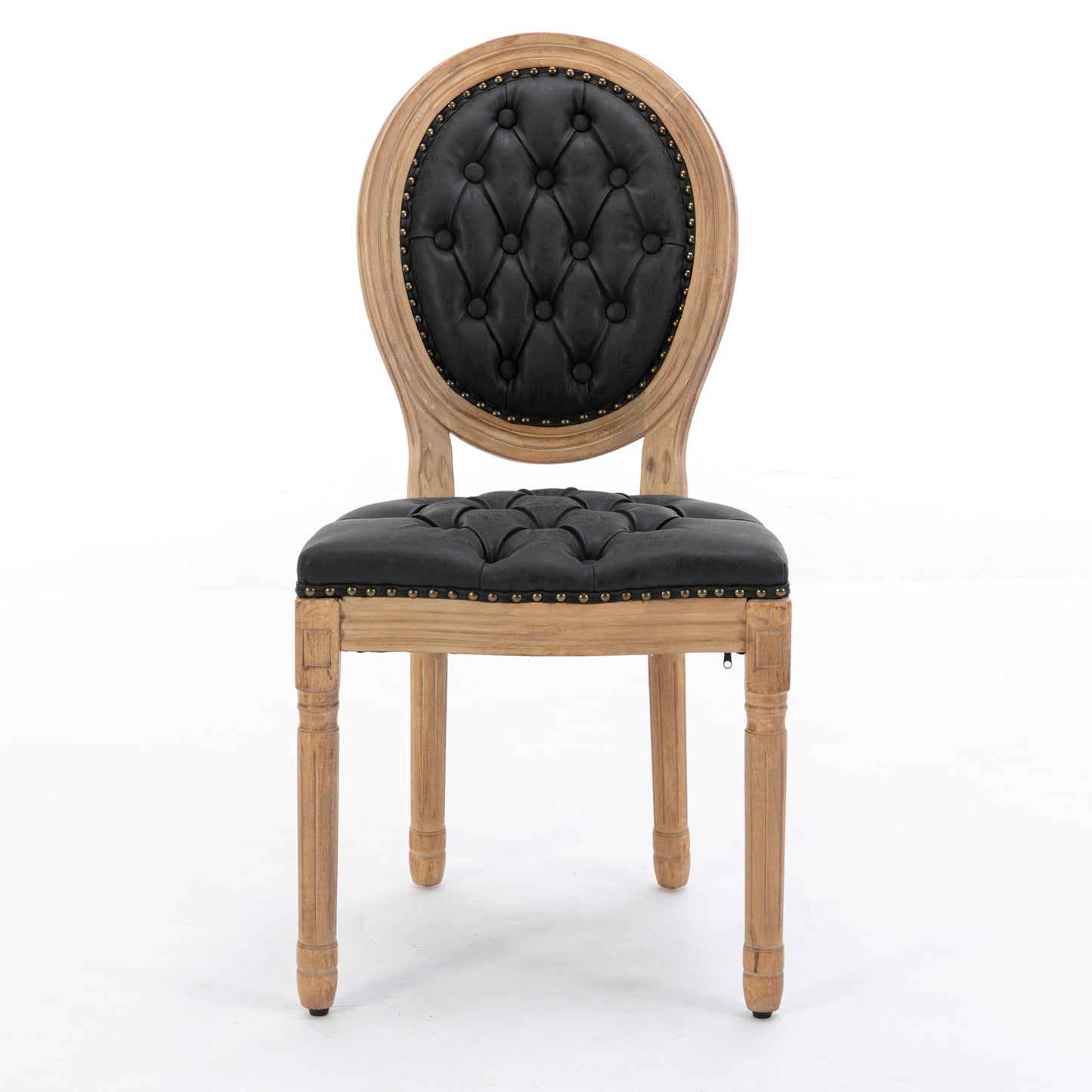 Tufted black leather armchair with distressed wood frame and ornate legs