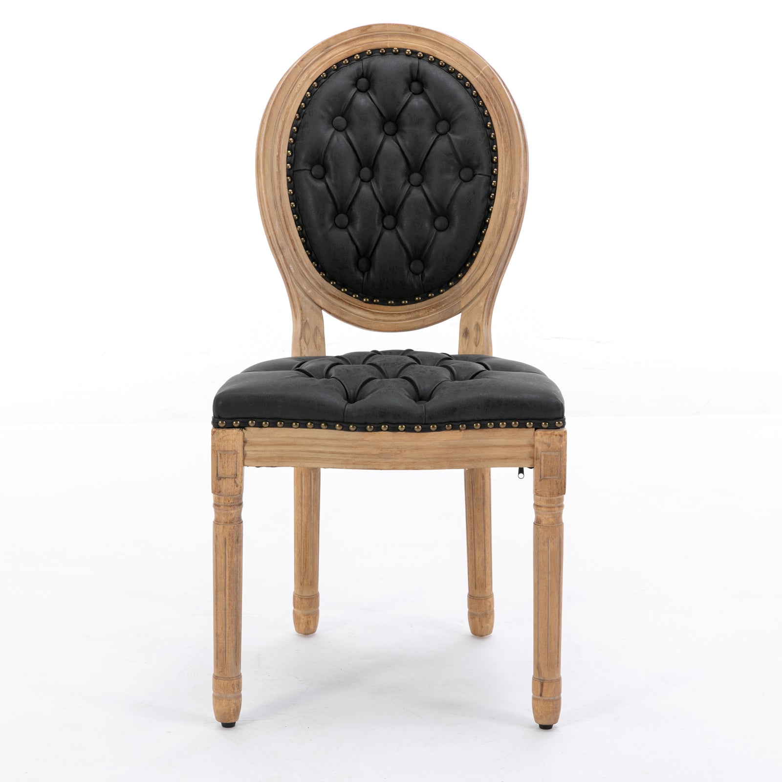 Tufted black leather armchair with distressed wood frame and ornate legs