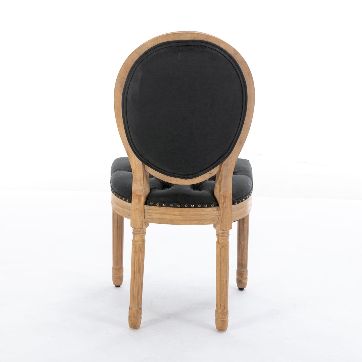Tufted black leather dining chair with ornate carved wood frame