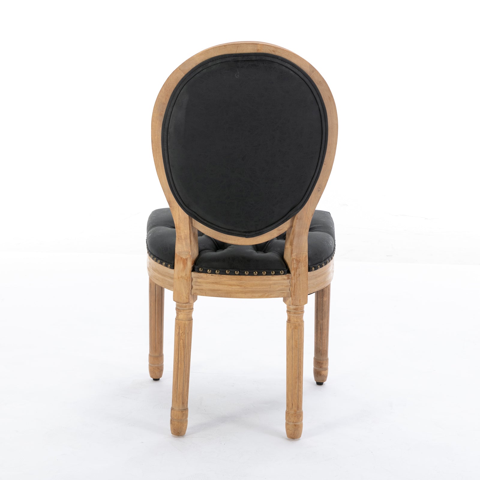 Tufted black leather dining chair with ornate carved wood frame