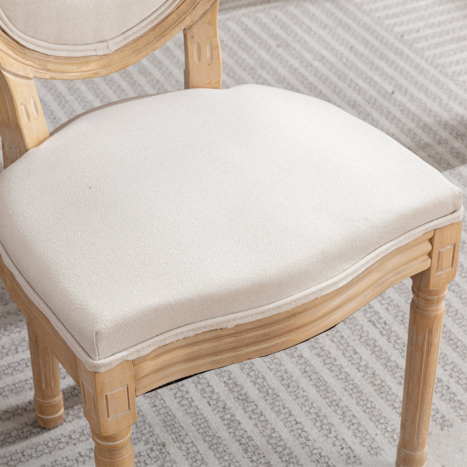 French country dining chair with upholstered cream seat and light wood frame