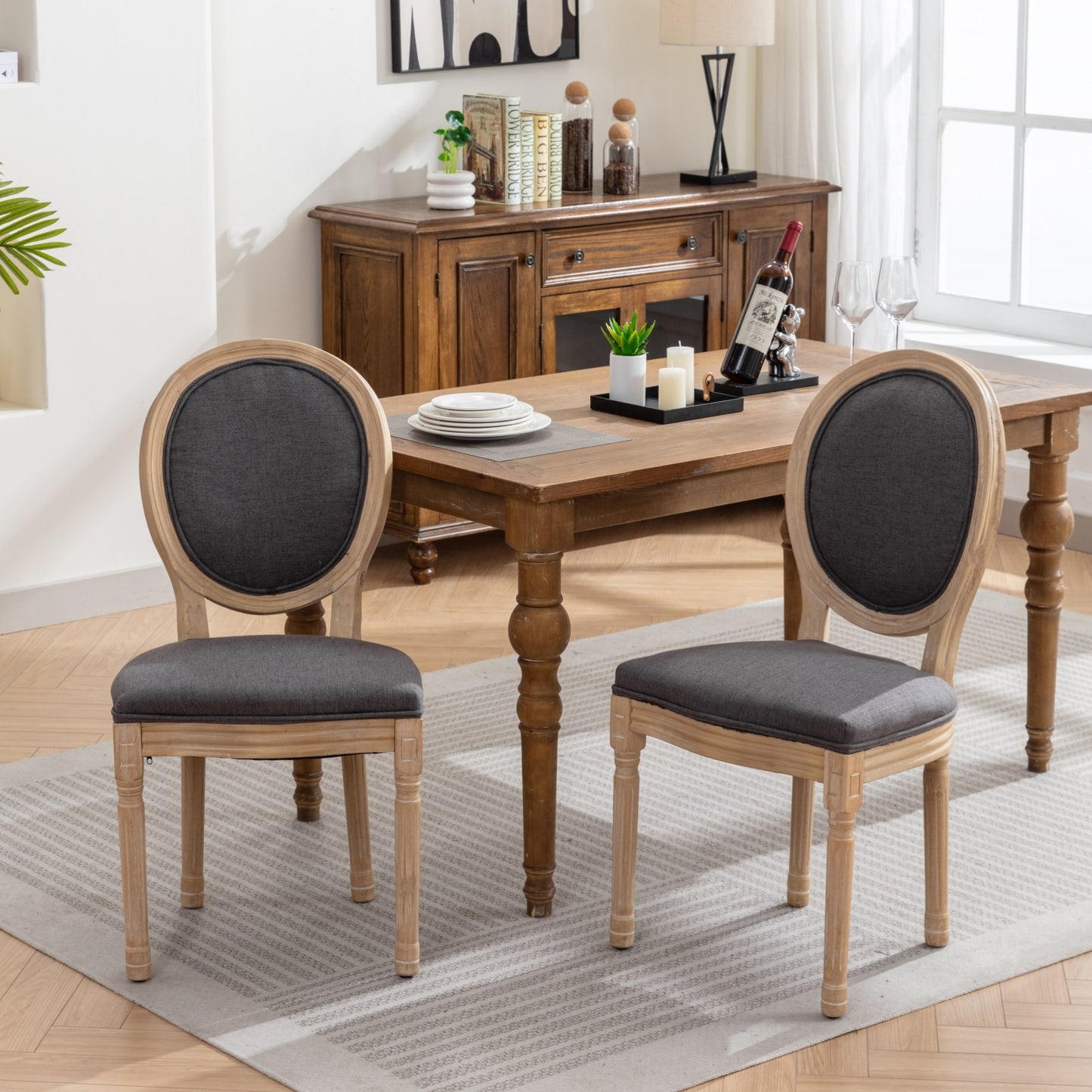 Dark grey upholstered oval back dining chair with light wood frame