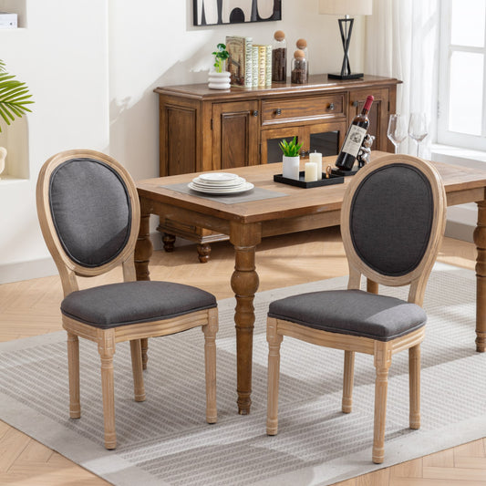 Pair of distressed wood oval back dining chairs with dark grey upholstered seats