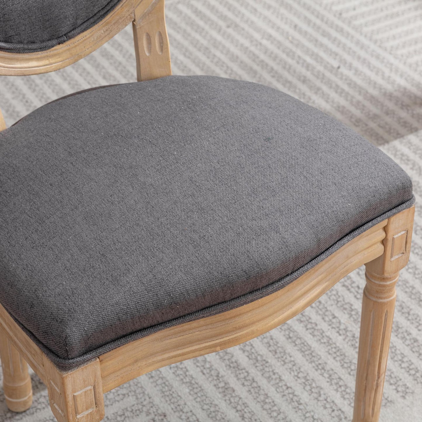 French country dining chair with grey upholstered seat and light wood frame