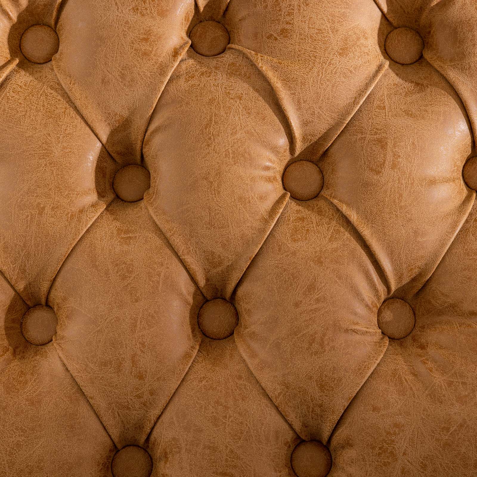 Closeup of a tan tufted leather upholstery swatch