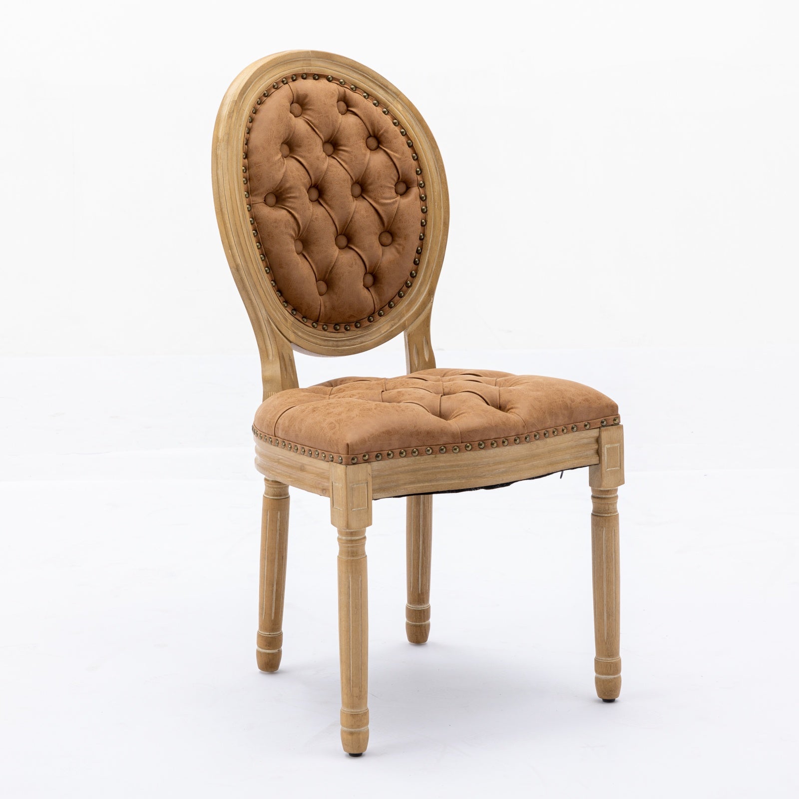 Tufted brown velvet armchair with carved light wood frame and antique brass nailhead trim