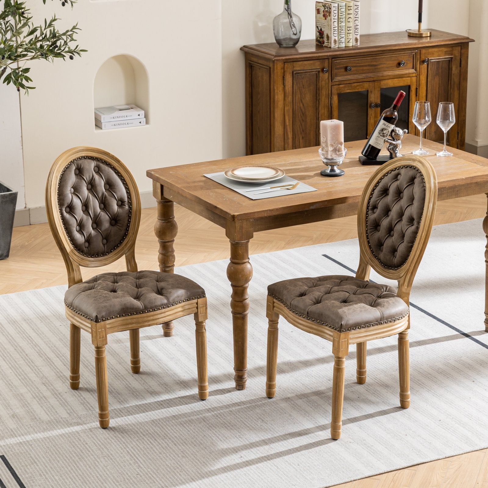 Tufted brown leather dining chair with distressed wood frame and nailhead trim
