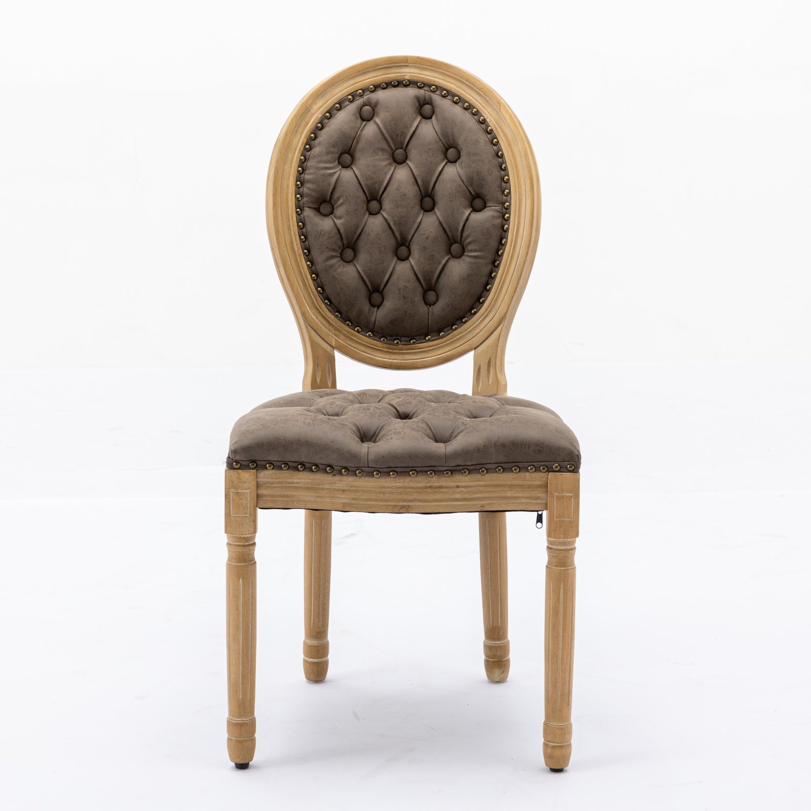 Tufted brown accent chair with distressed wood frame and brass nailhead trim