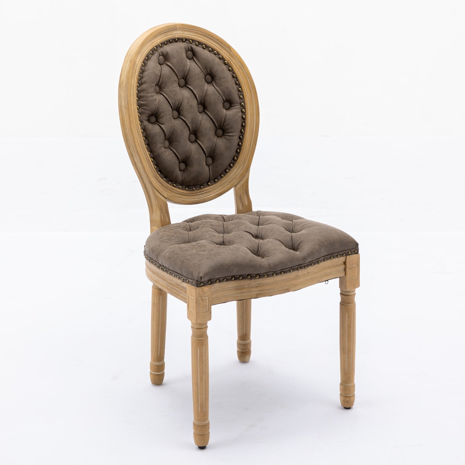 Tufted brown accent chair with distressed wood frame and brass nailhead trim