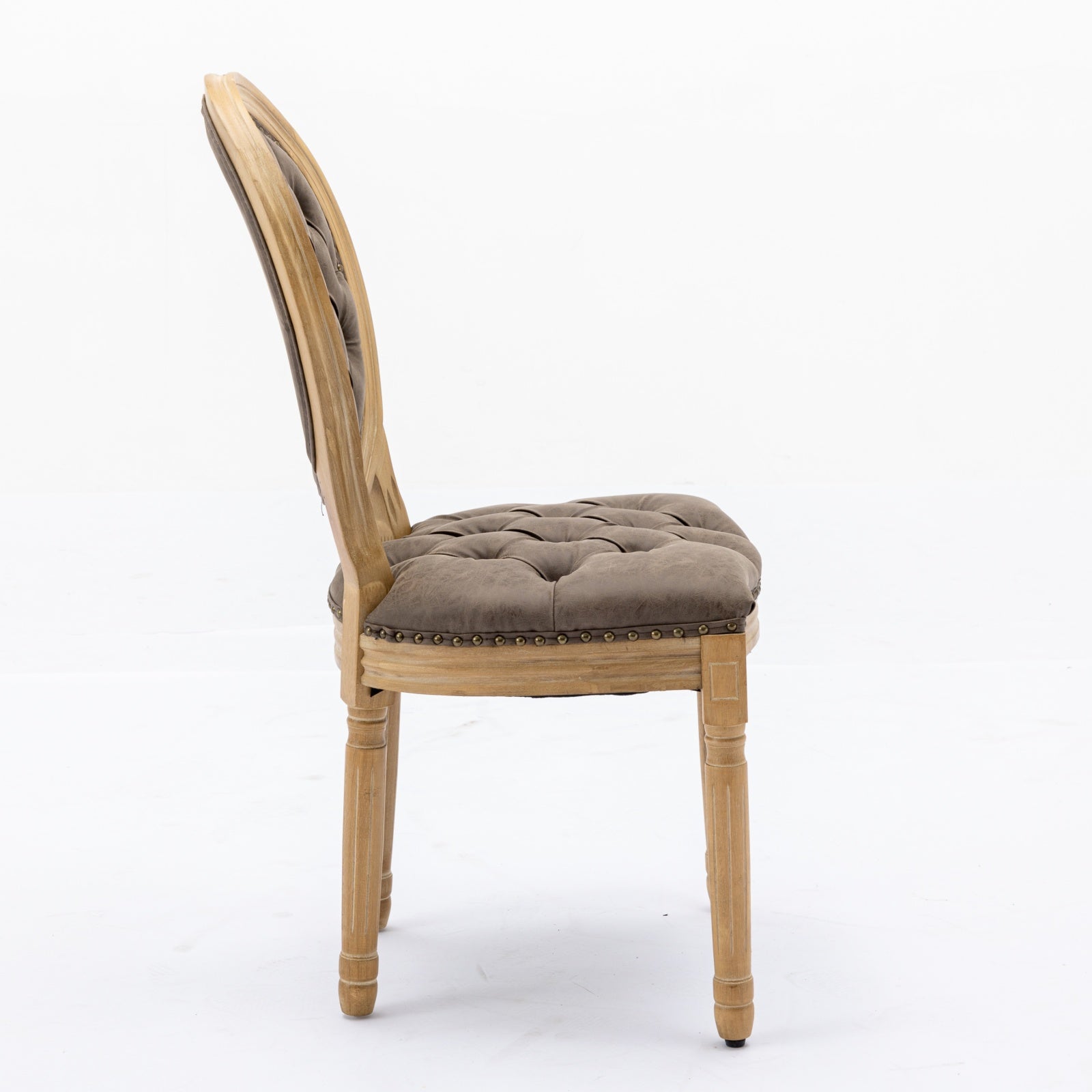 Ornate French dining chair with tufted taupe upholstery and distressed wood frame