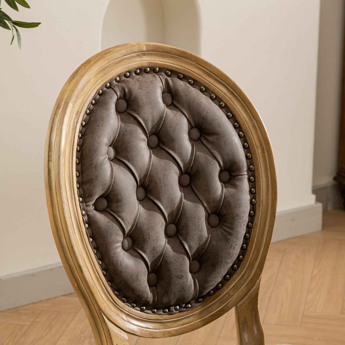 Tufted brown faux leather upholstered dining chair with antique wood frame