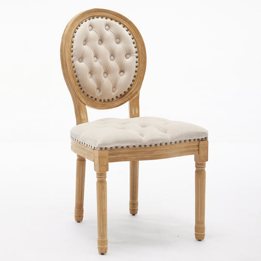 Tufted beige linen dining chair with carved wood frame and nailhead trim