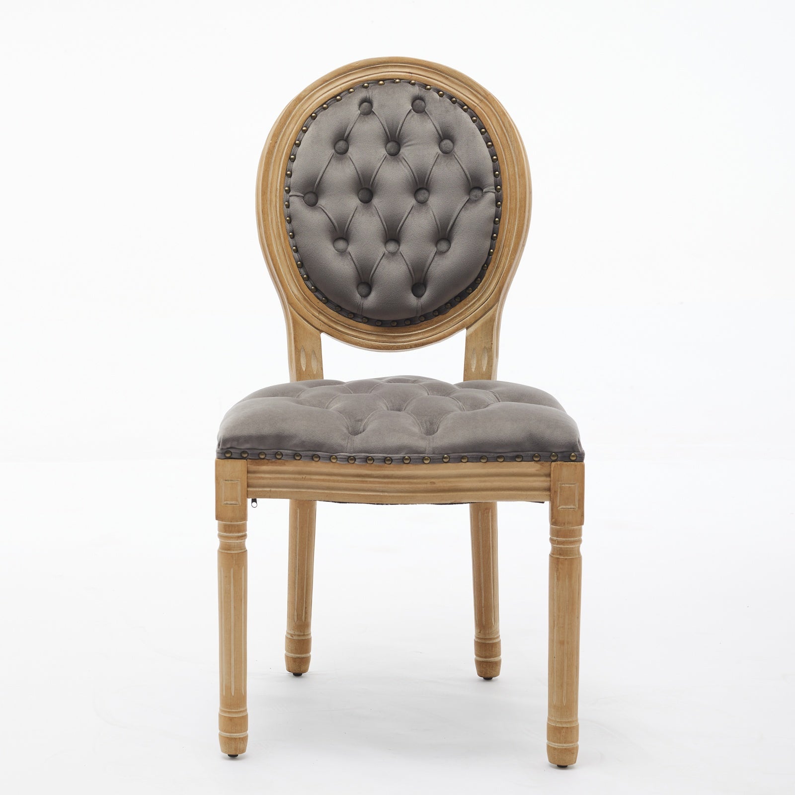 Grey tufted upholstered chair with distressed wood frame and nailhead trim