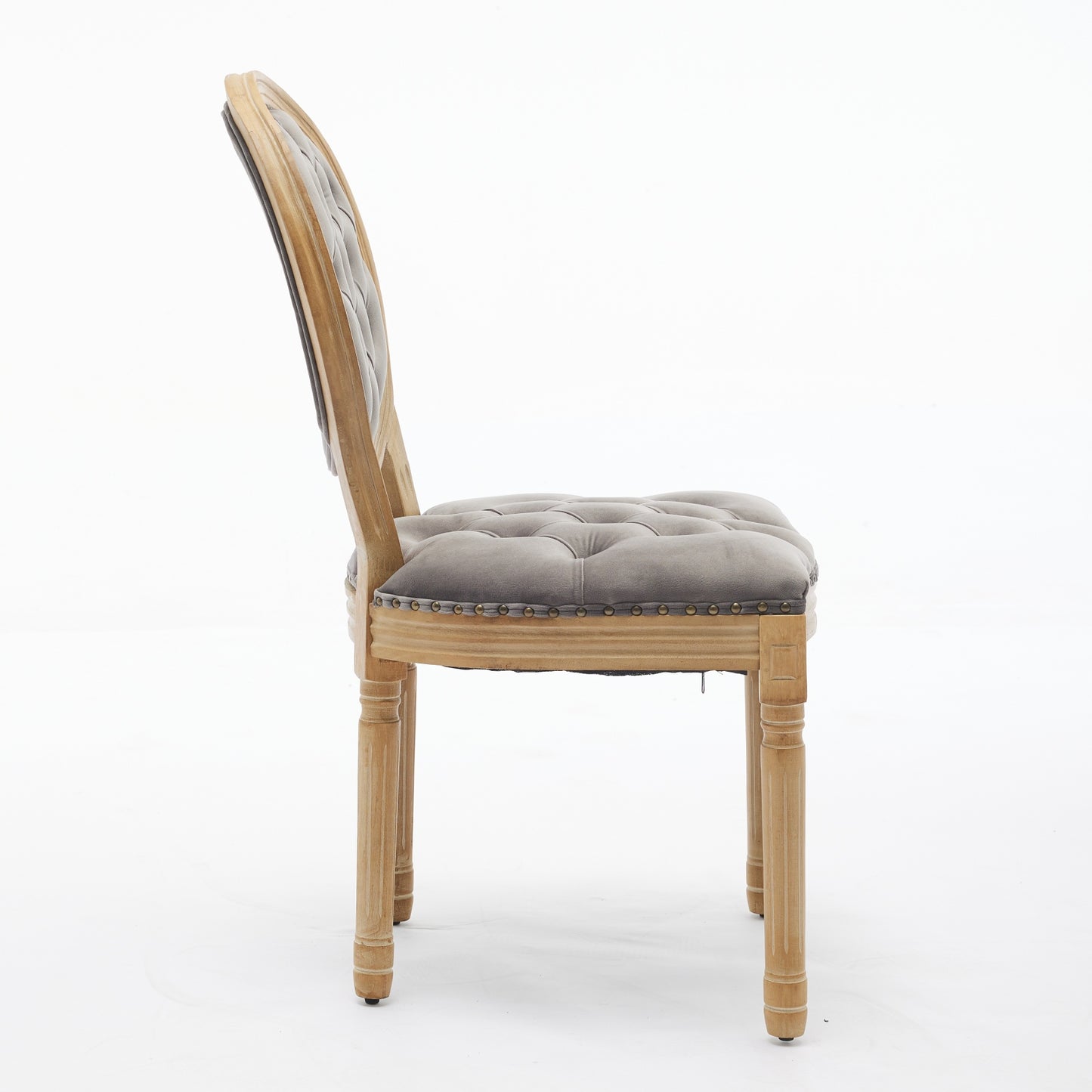 Tufted grey velvet dining chair with natural wood legs and nailhead trim