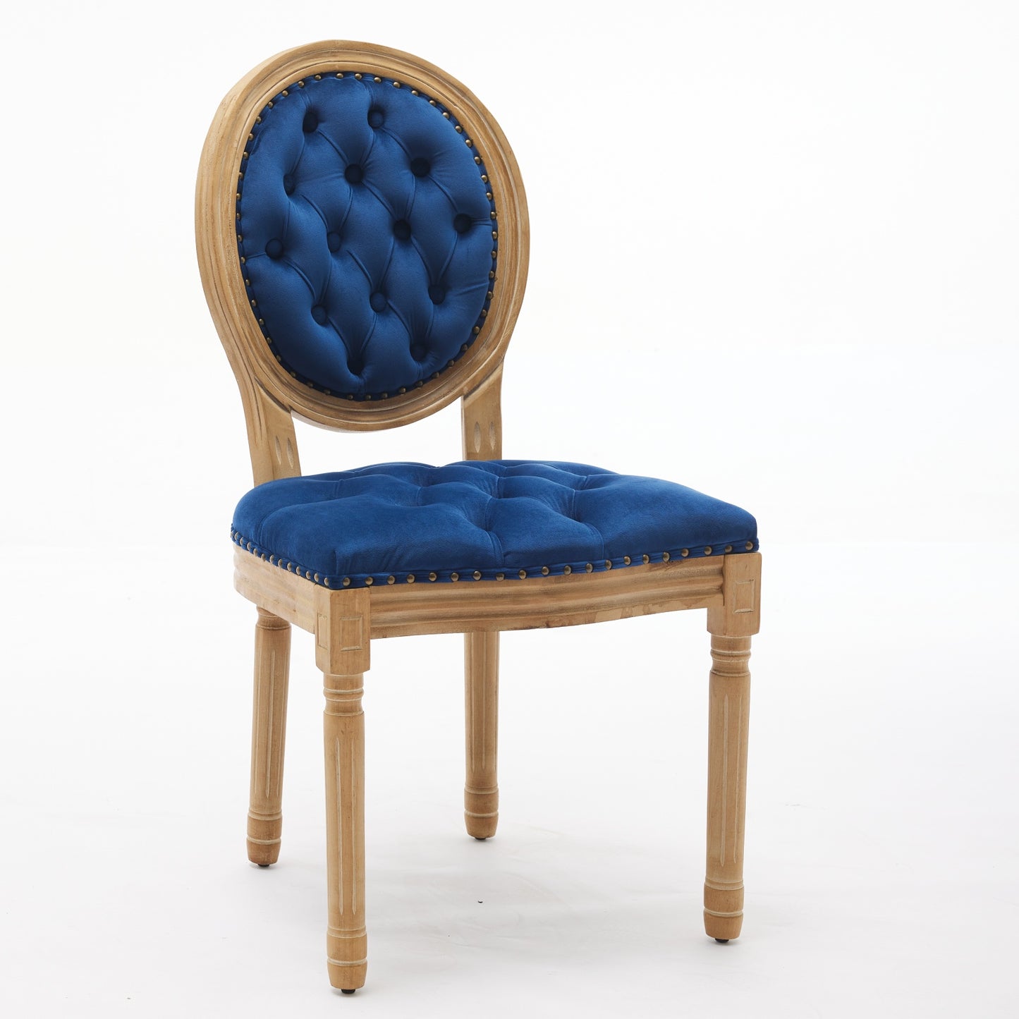 Tufted blue velvet accent chair with a natural wood frame and brass nailhead trim