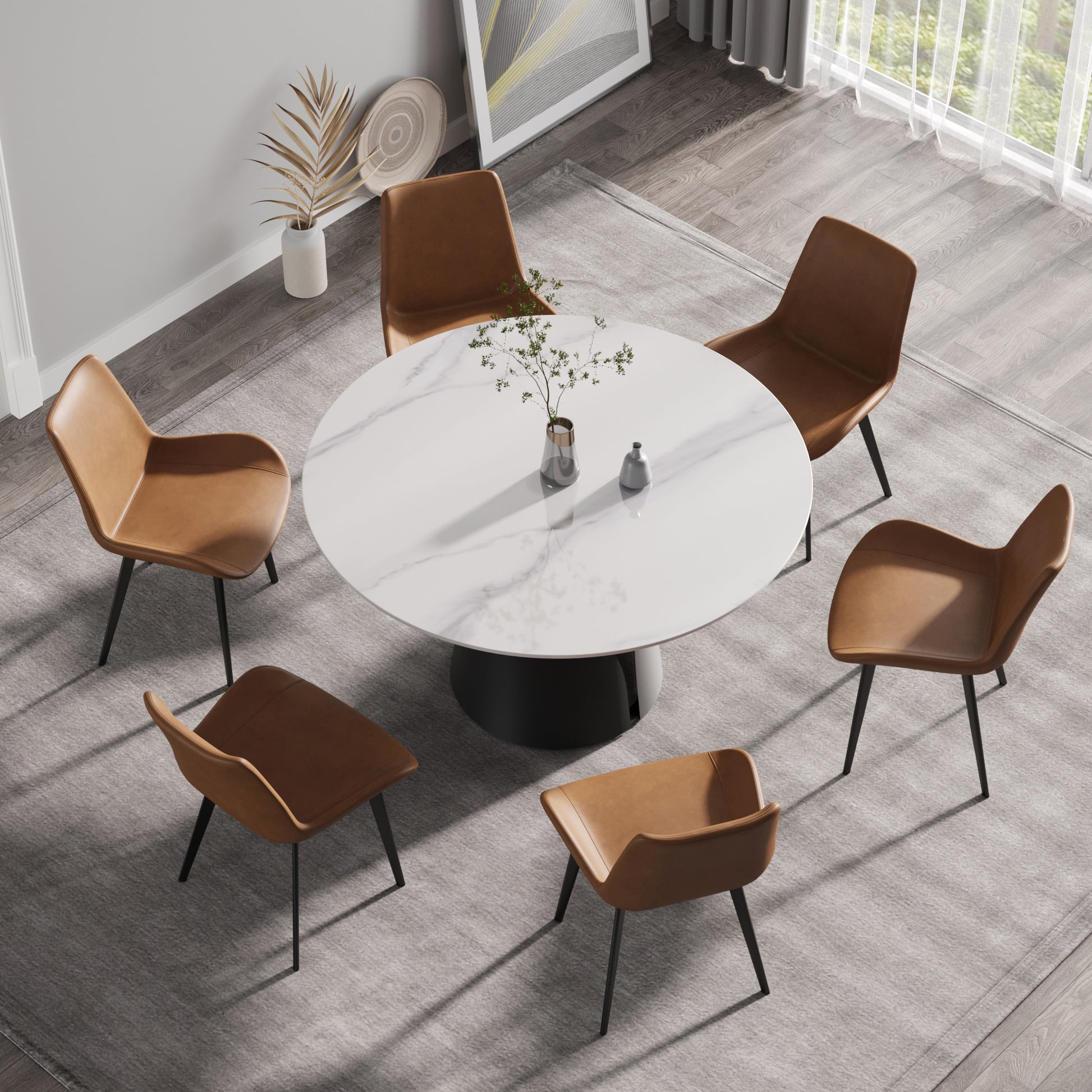 Round marble dining table with six brown leather chairs