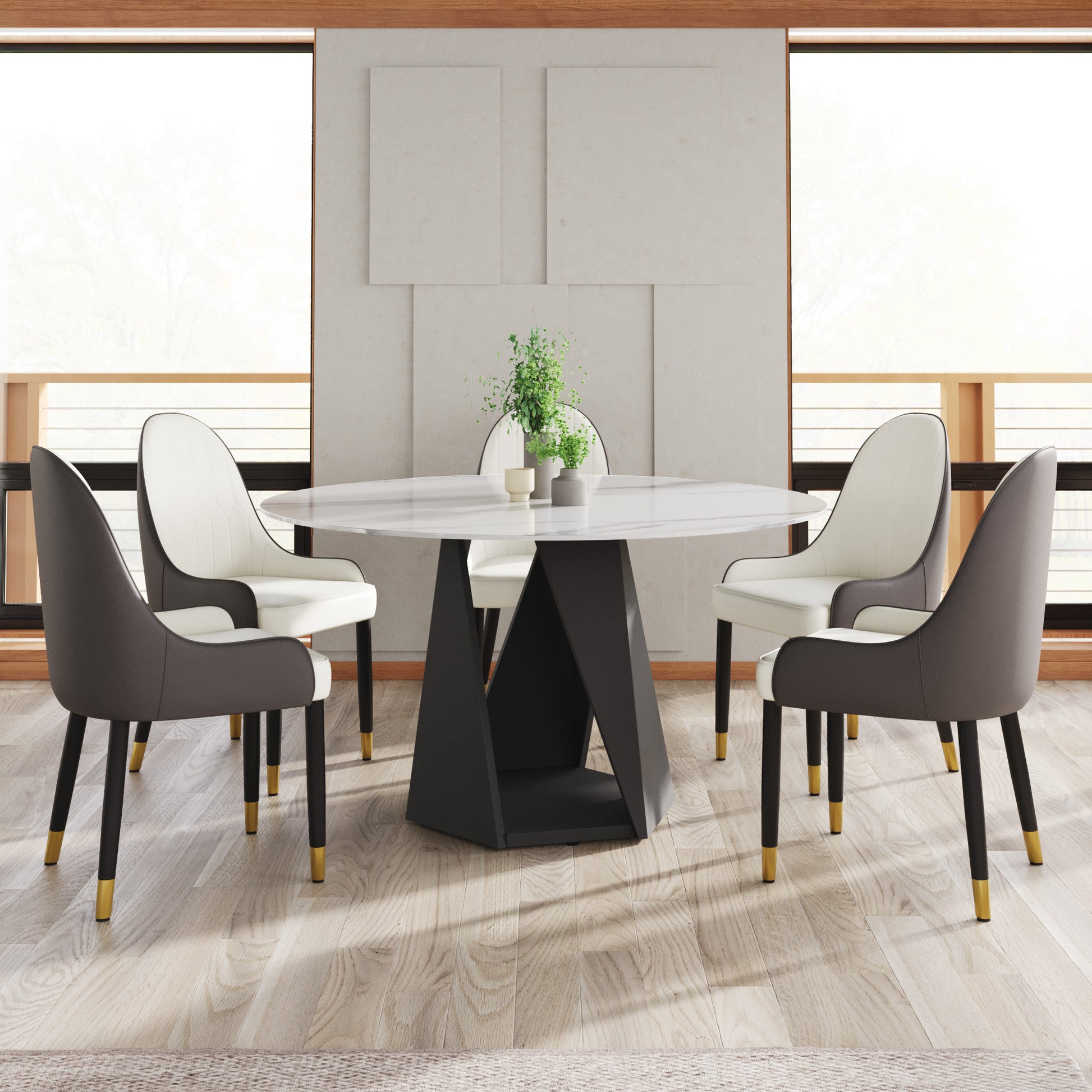 Modern white marble round dining table with black geometric base and upholstered chairs
