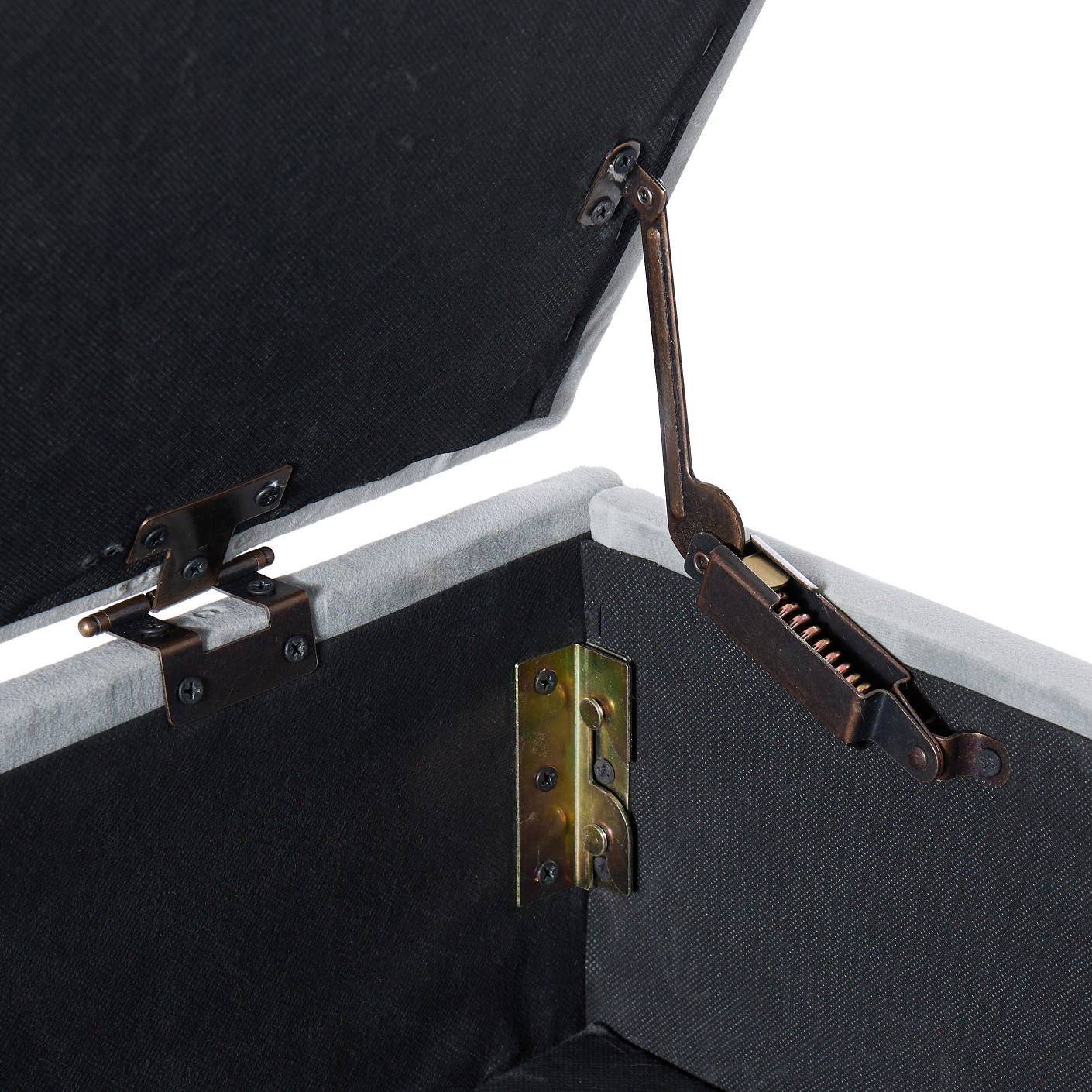 Closeup of hydraulic lid support mechanism for storage ottoman