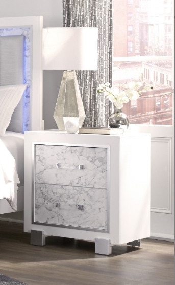 White marble inlay nightstand with chrome hardware and a modern geometric lamp