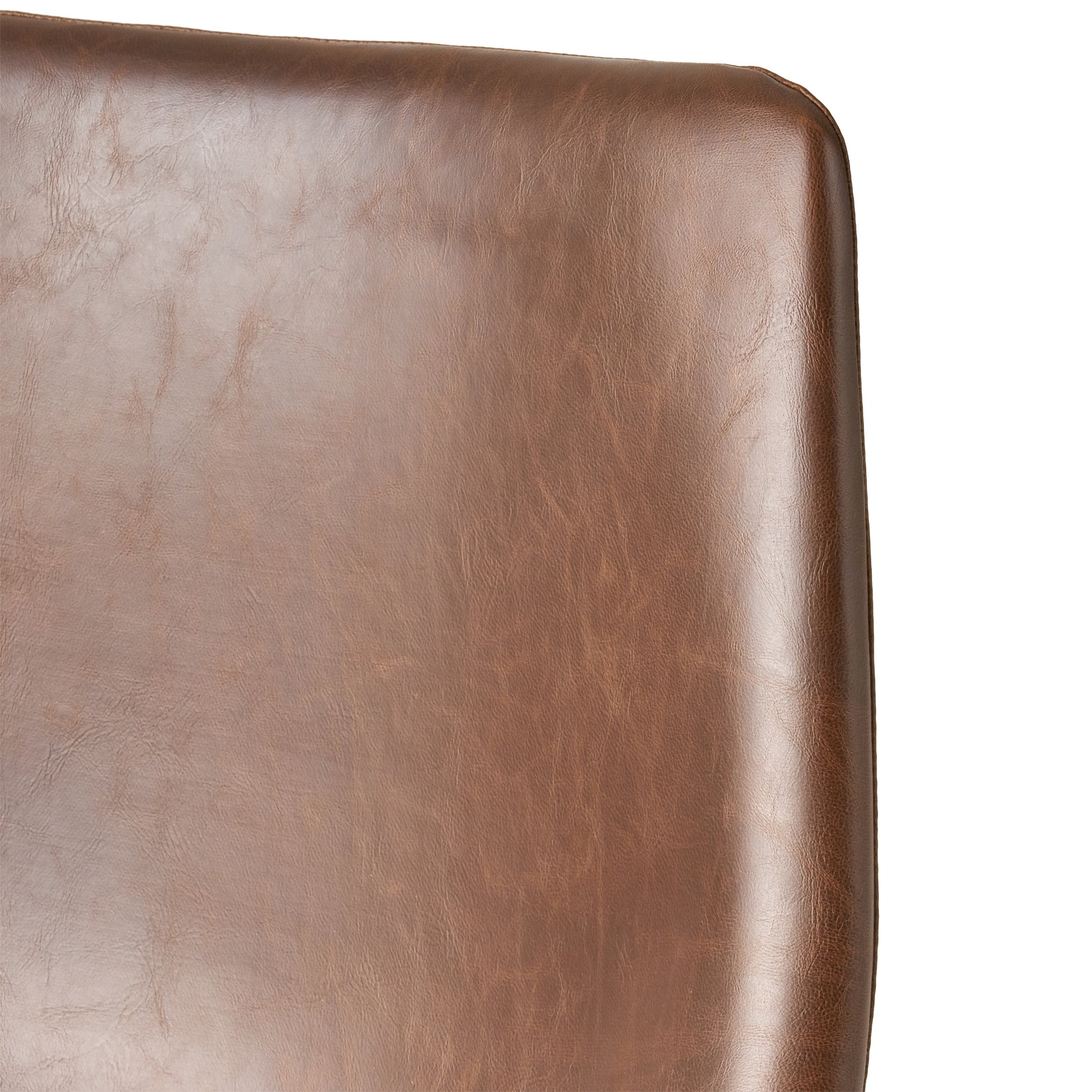 Closeup of a rich brown faux leather sofa with visible texture and stitching