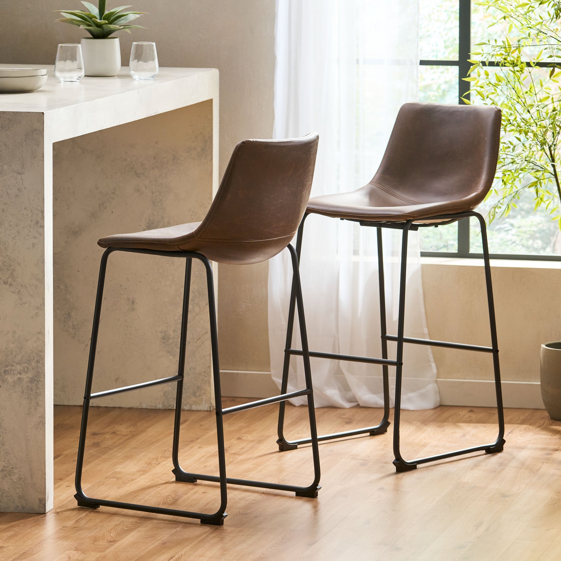 Brown faux leather bar stool with black metal legs